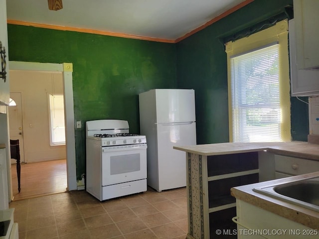 1000 N 6th, Quinton, OK 74561 - kitchen with white appliances, ornamental molding, and light countertops