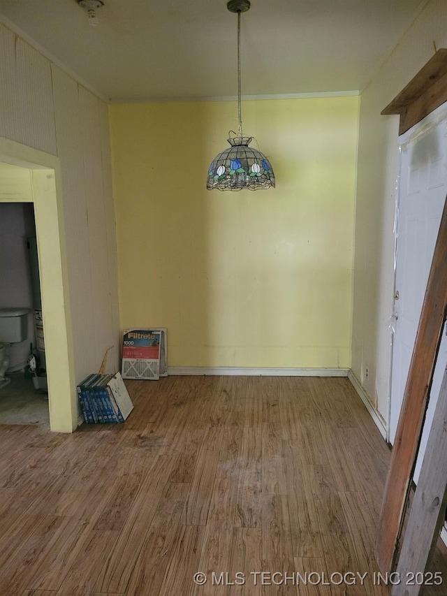 1000 N 6th, Quinton, OK 74561 - unfurnished dining area with wood finished floors