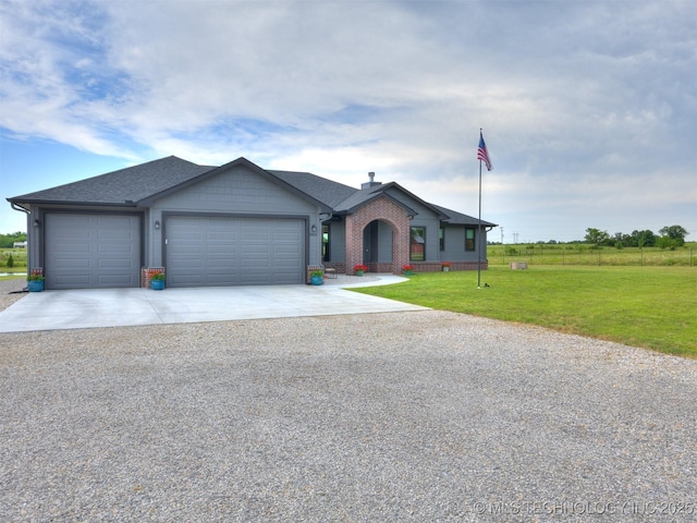 8859 N 50th W Ave, Sperry, OK 74073 - view of front of home featuring an attached garage, concrete driveway, a front yard, and brick siding