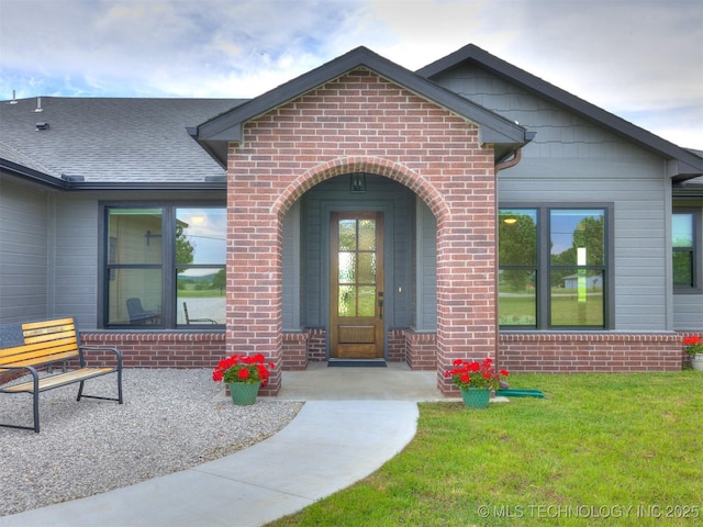 8859 N 50th W Ave, Sperry, OK 74073 - doorway to property featuring brick siding, a lawn, and roof with shingles
