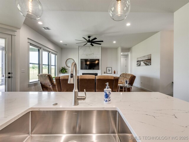 8859 N 50th W Ave, Sperry, OK 74073 - kitchen featuring a sink, open floor plan, recessed lighting, light stone countertops, and ceiling fan
