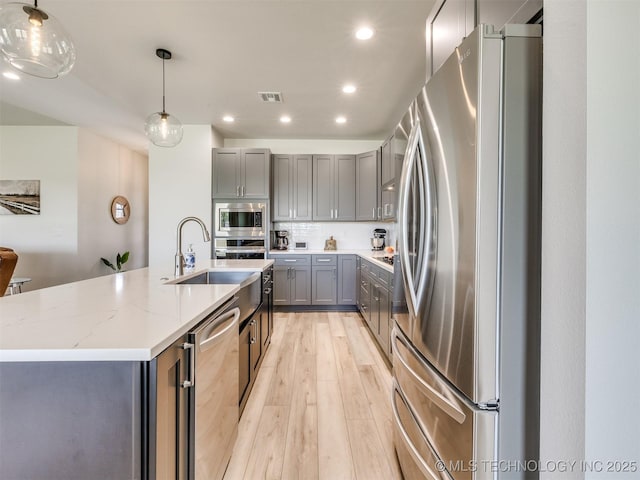 8859 N 50th W Ave, Sperry, OK 74073 - kitchen featuring appliances with stainless steel finishes, gray cabinetry, light wood-style floors, a sink, and recessed lighting