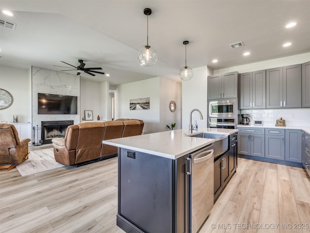 8859 N 50th W Ave, Sperry, OK 74073 - kitchen featuring stainless steel appliances, light wood-style floors, a sink, open floor plan, and recessed lighting