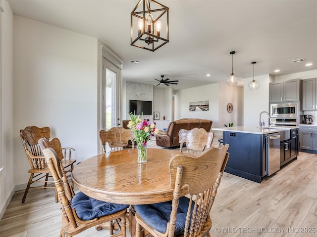 8859 N 50th W Ave, Sperry, OK 74073 - dining area featuring light wood-style floors, recessed lighting, a chandelier, ceiling fan, and baseboards