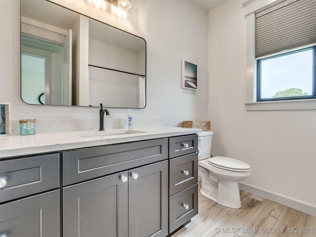 8859 N 50th W Ave, Sperry, OK 74073 - full bath with wood finished floors, baseboards, toilet, vanity, and a shower