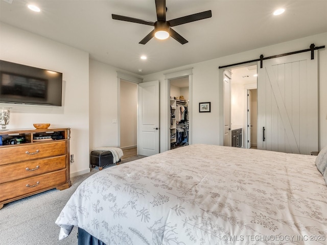 8859 N 50th W Ave, Sperry, OK 74073 - carpeted bedroom with a barn door, recessed lighting, a walk in closet, a ceiling fan, and a closet