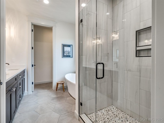 8859 N 50th W Ave, Sperry, OK 74073 - bathroom featuring a soaking tub, vanity, a stall shower, recessed lighting, and baseboards