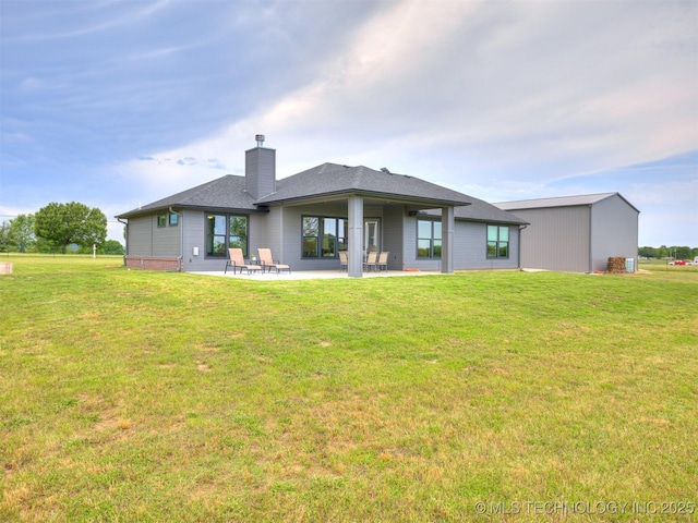 8859 N 50th W Ave, Sperry, OK 74073 - rear view of house featuring a chimney, a patio, and a lawn