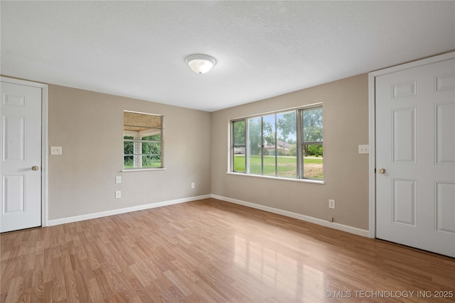 607 E Schley St, Vian, OK 74962 - spare room featuring light wood-type flooring, baseboards, and plenty of natural light