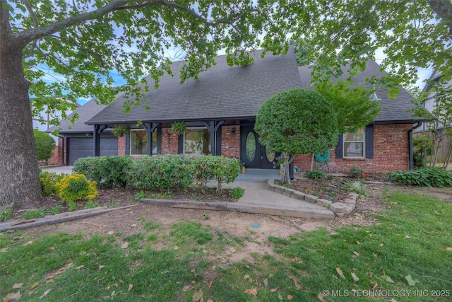 8221 S 74th E Ave, Tulsa, OK 74133 - view of front of house featuring brick siding, a garage, and roof with shingles