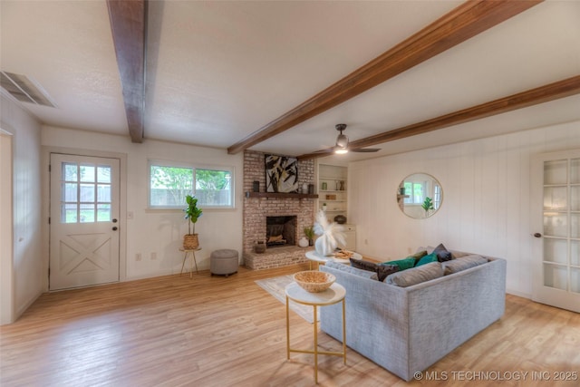 8221 S 74th E Ave, Tulsa, OK 74133 - living room featuring light wood-type flooring, beamed ceiling, a fireplace, and ceiling fan