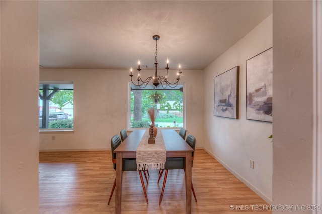 8221 S 74th E Ave, Tulsa, OK 74133 - dining room with a chandelier, light wood finished floors, and baseboards