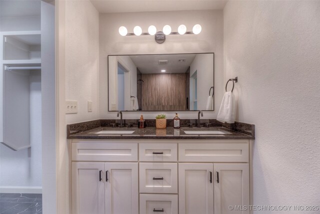 8221 S 74th E Ave, Tulsa, OK 74133 - bathroom featuring double vanity, marble look tiles, and baseboards