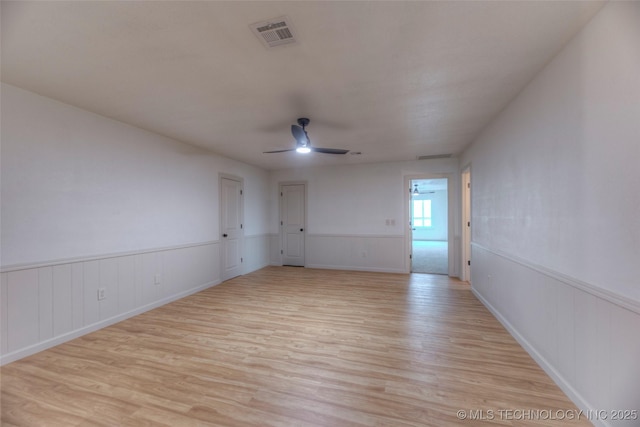 8221 S 74th E Ave, Tulsa, OK 74133 - spare room featuring light wood-style flooring, ceiling fan, and wainscoting