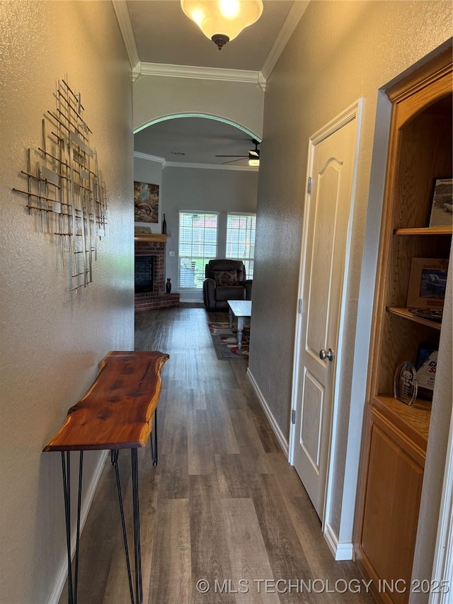 9701 N 98th E Ave, Owasso, OK 74055 - corridor featuring dark wood-style floors, crown molding, arched walkways, baseboards, and a textured wall