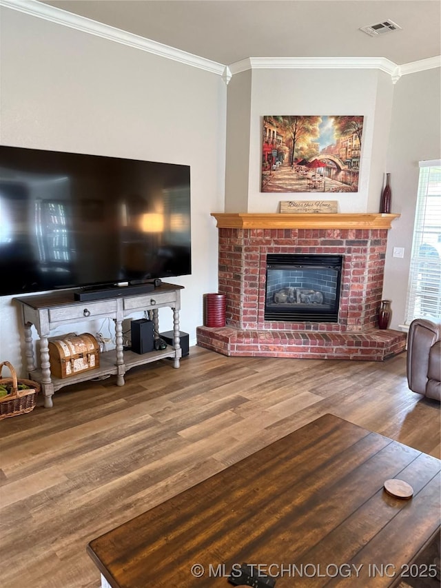 9701 N 98th E Ave, Owasso, OK 74055 - living area featuring crown molding, wood finished floors, and a brick fireplace