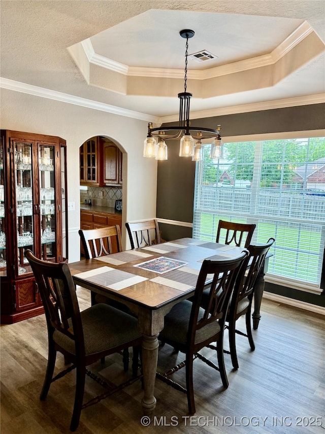 9701 N 98th E Ave, Owasso, OK 74055 - dining space featuring a tray ceiling, light wood-style flooring, plenty of natural light, and crown molding