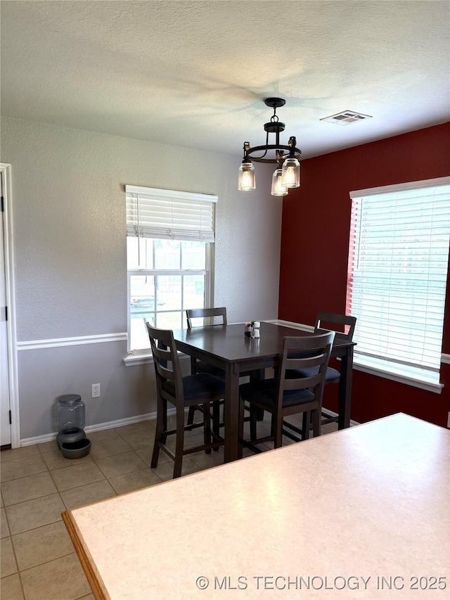 9701 N 98th E Ave, Owasso, OK 74055 - dining space featuring tile patterned floors, a chandelier, and baseboards