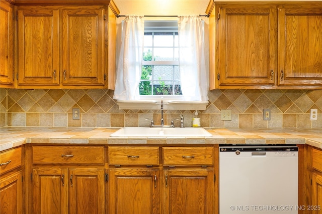 4605 Skylane Dr, Sand Springs, OK 74063 - kitchen with dishwasher, a sink, brown cabinets, and light countertops