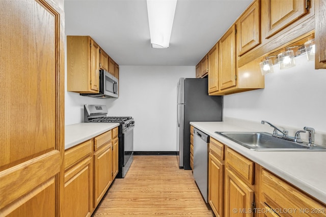 410 W 7th St Unit 1122, Tulsa, OK 74119 - kitchen featuring stainless steel appliances, a sink, light wood-style flooring, light countertops, and brown cabinets
