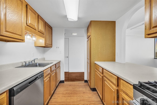 410 W 7th St Unit 1122, Tulsa, OK 74119 - kitchen featuring stainless steel dishwasher, a sink, light wood-type flooring, light countertops, and brown cabinetry
