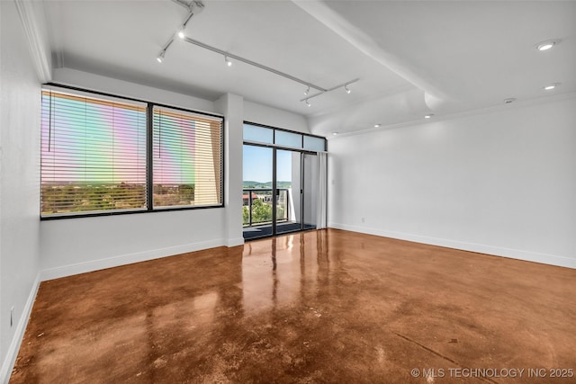 410 W 7th St Unit 1122, Tulsa, OK 74119 - empty room with finished concrete floors, baseboards, rail lighting, and attic access