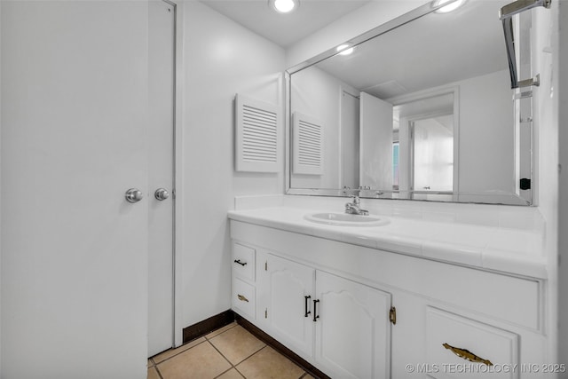 410 W 7th St Unit 1122, Tulsa, OK 74119 - bathroom featuring vanity, tile patterned flooring, and baseboards