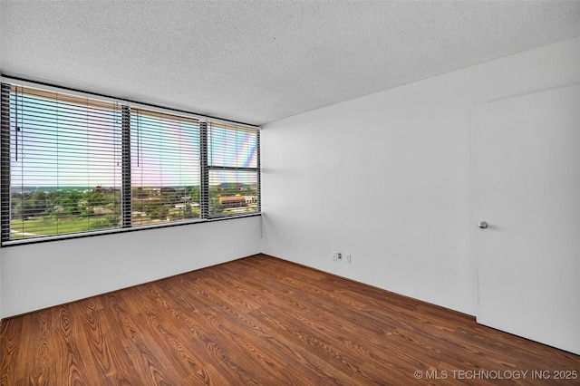 410 W 7th St Unit 1122, Tulsa, OK 74119 - spare room with a textured ceiling and wood finished floors