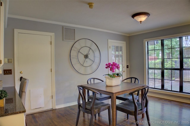 10520 S 69th E Ave, Tulsa, OK 74133 - dining area with dark wood finished floors, ornamental molding, and baseboards
