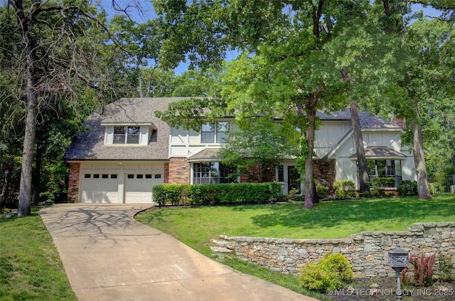 10520 S 69th E Ave, Tulsa, OK 74133 - english style home with driveway, a front lawn, a garage, brick siding, and roof with shingles