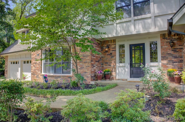 10520 S 69th E Ave, Tulsa, OK 74133 - view of exterior entry with brick siding and an attached garage