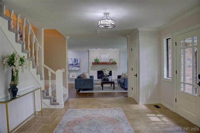 10520 S 69th E Ave, Tulsa, OK 74133 - foyer entrance featuring stone tile floors, baseboards, stairway, a fireplace, and crown molding