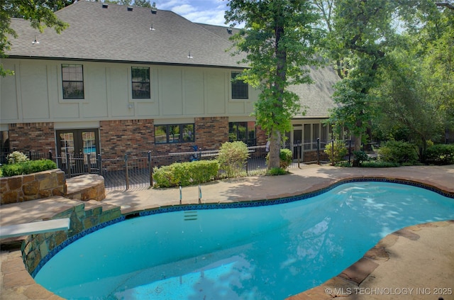 10520 S 69th E Ave, Tulsa, OK 74133 - outdoor pool featuring french doors, a diving board, a patio, and a sunroom