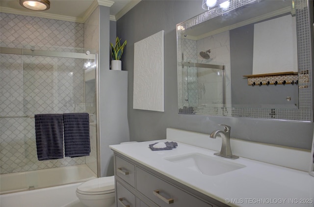 10520 S 69th E Ave, Tulsa, OK 74133 - bathroom featuring ornamental molding, vanity, toilet, and bath / shower combo with glass door