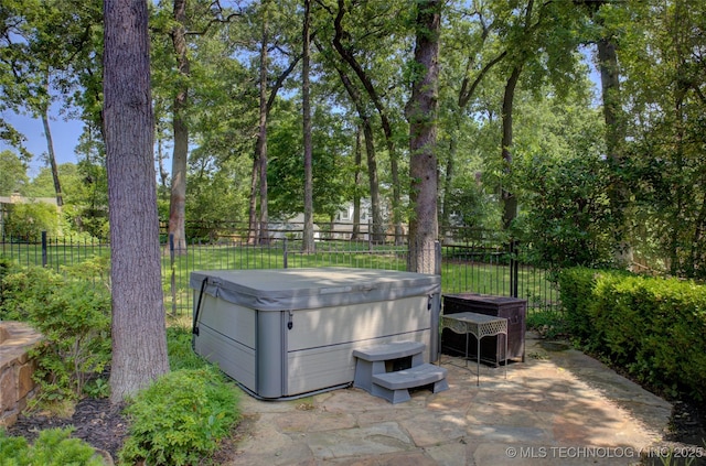 10520 S 69th E Ave, Tulsa, OK 74133 - view of patio / terrace featuring a hot tub and view of wooded area