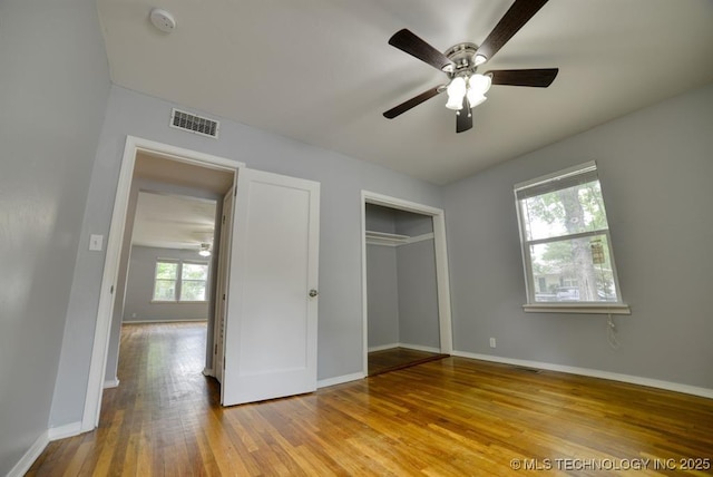 916 S Orchard St, Stillwater, OK 74074 - unfurnished bedroom featuring wood finished floors, baseboards, a closet, and ceiling fan