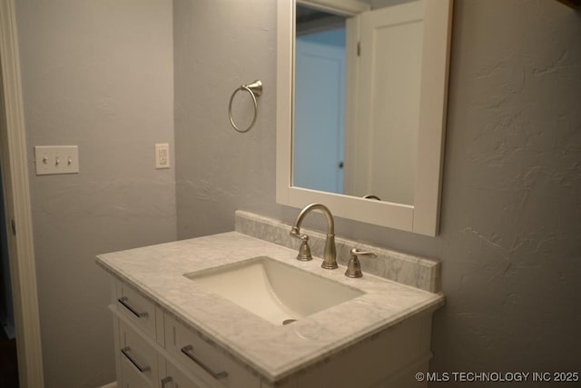 916 S Orchard St, Stillwater, OK 74074 - bathroom featuring vanity and a textured wall