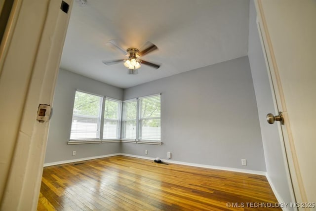 916 S Orchard St, Stillwater, OK 74074 - spare room featuring hardwood / wood-style flooring, baseboards, and ceiling fan