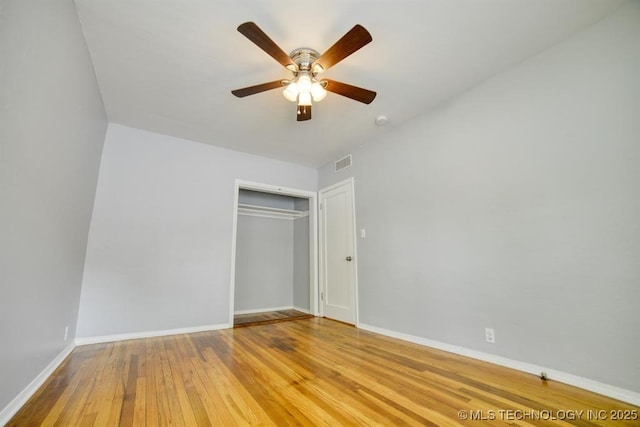 916 S Orchard St, Stillwater, OK 74074 - unfurnished bedroom featuring hardwood / wood-style flooring, baseboards, a closet, and ceiling fan