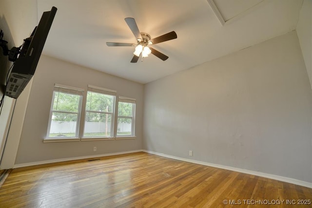 916 S Orchard St, Stillwater, OK 74074 - empty room with wood finished floors, baseboards, a ceiling fan, and attic access