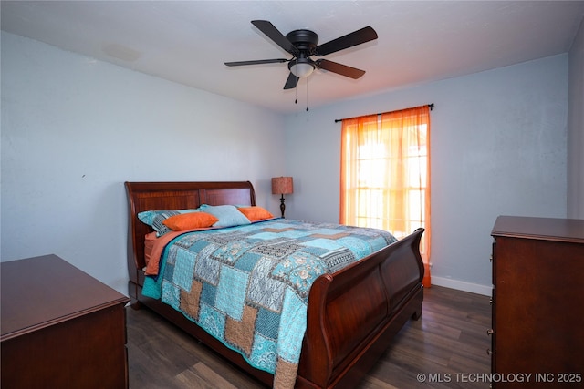 8845 Chestnut Rd, Henryetta, OK 74437 - bedroom with dark wood-type flooring, baseboards, and a ceiling fan