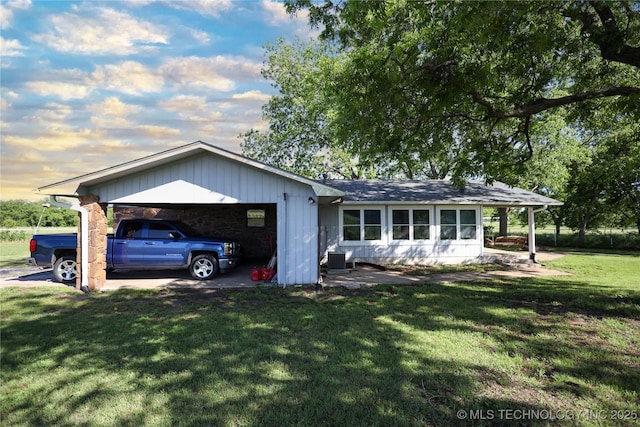 8845 Chestnut Rd, Henryetta, OK 74437 - view of front of house with a front lawn, a garage, and central air condition unit