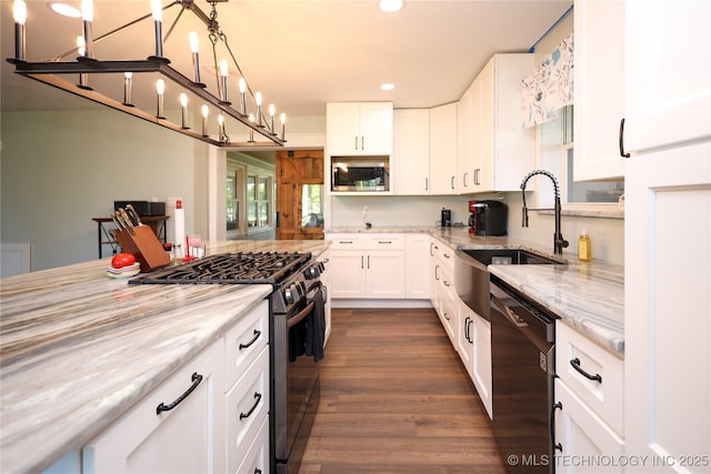8845 Chestnut Rd, Henryetta, OK 74437 - kitchen with appliances with stainless steel finishes, recessed lighting, light stone countertops, white cabinetry, and a sink