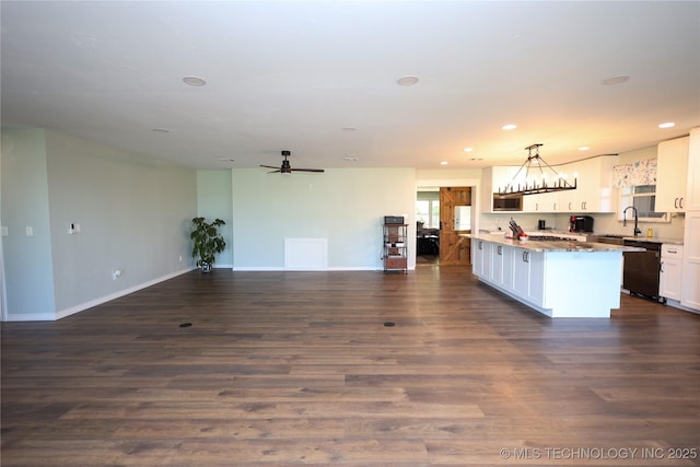 8845 Chestnut Rd, Henryetta, OK 74437 - kitchen featuring dishwasher, white cabinets, recessed lighting, open floor plan, and baseboards
