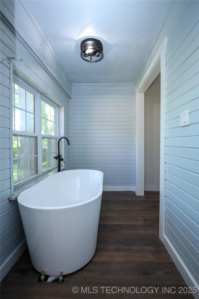 8845 Chestnut Rd, Henryetta, OK 74437 - full bathroom with a freestanding tub, baseboards, wood finished floors, and wood walls