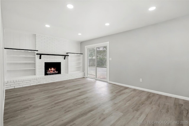 11607 E 24th St, Tulsa, OK 74129 - unfurnished living room featuring wood finished floors, recessed lighting, a fireplace, and baseboards