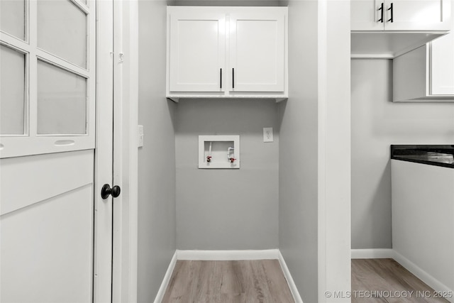 11607 E 24th St, Tulsa, OK 74129 - washroom featuring washer hookup, cabinet space, light wood-style floors, and baseboards