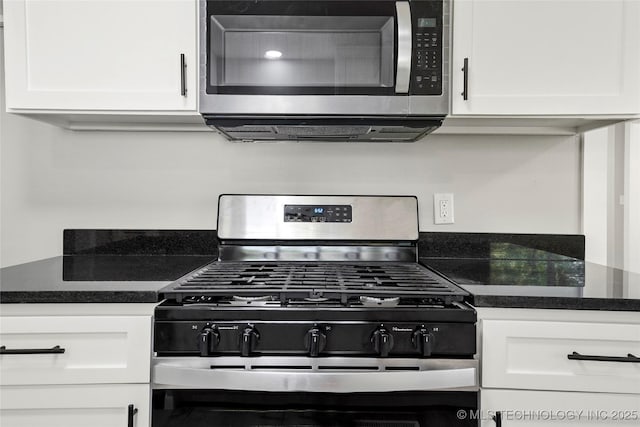 11607 E 24th St, Tulsa, OK 74129 - kitchen featuring stainless steel appliances, dark countertops, and white cabinets