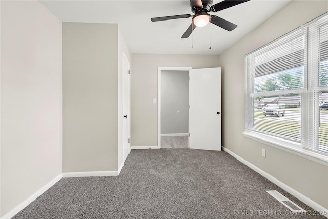 11607 E 24th St, Tulsa, OK 74129 - unfurnished bedroom featuring carpet flooring, baseboards, and ceiling fan