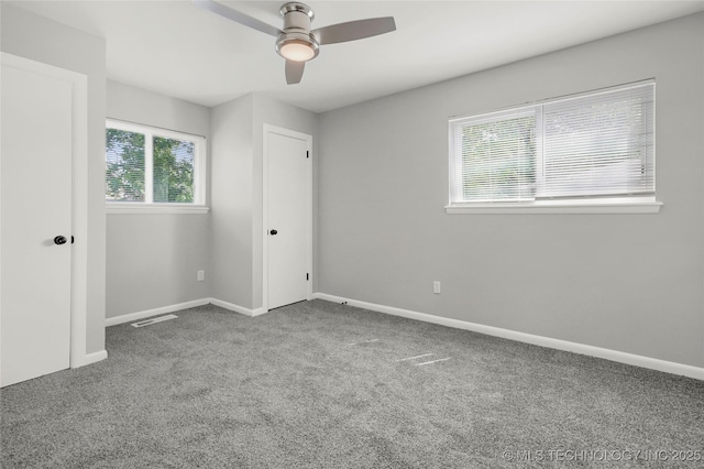 11607 E 24th St, Tulsa, OK 74129 - unfurnished bedroom with carpet flooring, baseboards, and a ceiling fan